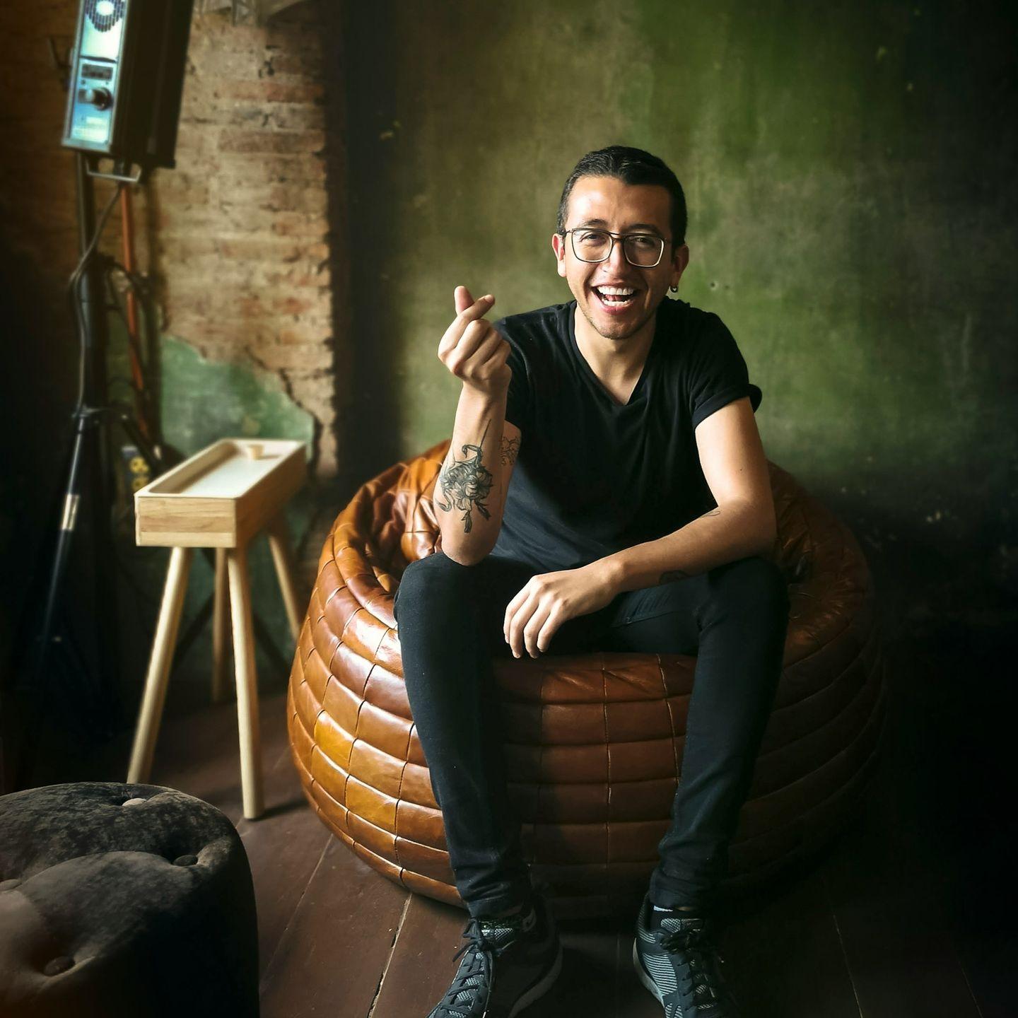 unknown person sitting on brown chair indoors